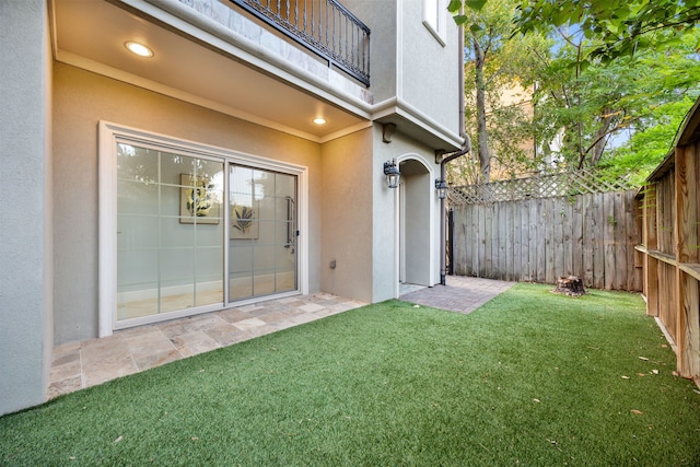 exterior space with a balcony and fence