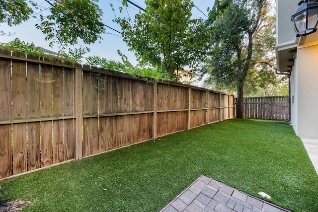 view of yard with a fenced backyard