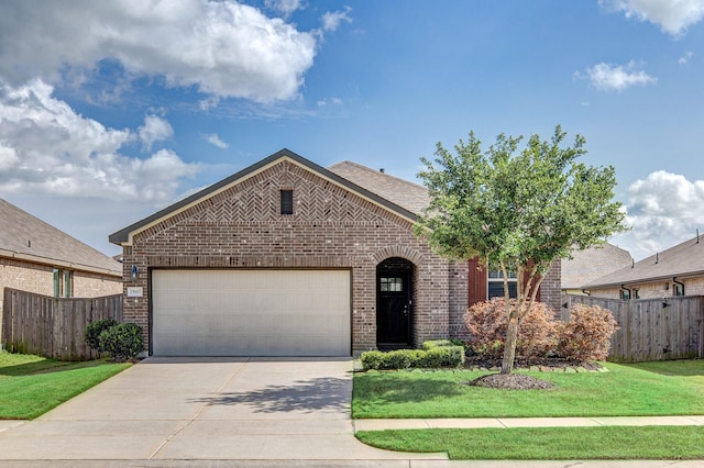 view of front of house with fence, an attached garage, driveway, and brick siding