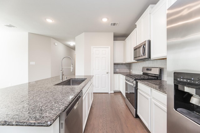 kitchen with visible vents, appliances with stainless steel finishes, dark wood-style floors, and a sink