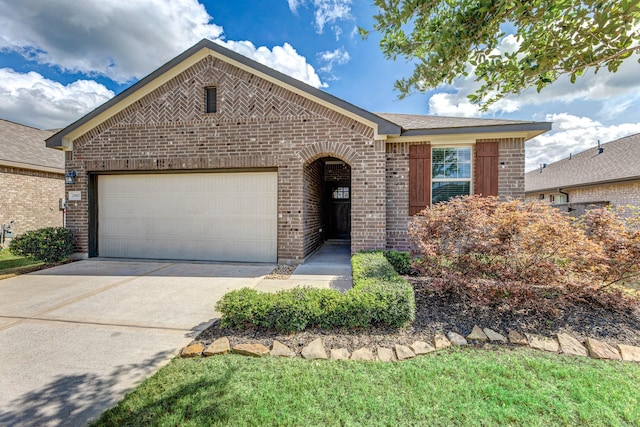 single story home featuring concrete driveway, an attached garage, and brick siding