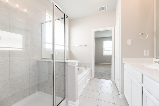 full bathroom featuring a bath, visible vents, tile patterned flooring, a shower stall, and vanity