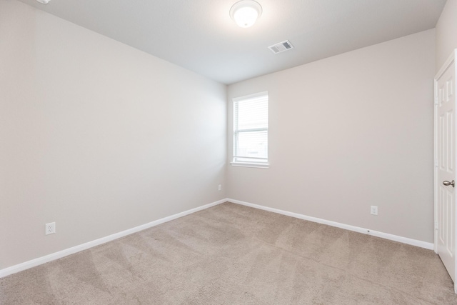 unfurnished room featuring baseboards, visible vents, and carpet floors