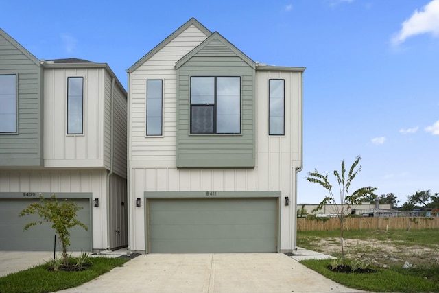 8411 Pech Landing Dr, Houston, TX 77055 - view of front of house with an attached garage, concrete driveway, and board and batten siding