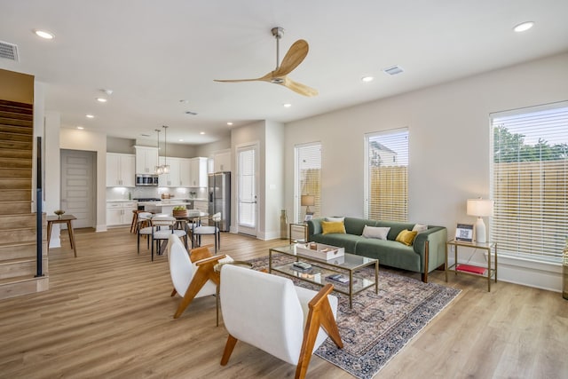 8411 Pech Landing Dr, Houston, TX 77055 - living area featuring stairway, light wood-style flooring, ceiling fan, recessed lighting, and baseboards