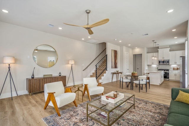 8411 Pech Landing Dr, Houston, TX 77055 - living room with a ceiling fan, stairway, light wood finished floors, baseboards, and recessed lighting