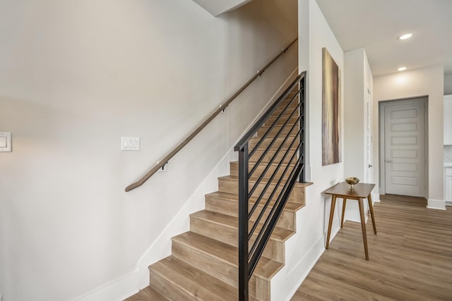 8411 Pech Landing Dr, Houston, TX 77055 - stairway featuring baseboards, wood finished floors, and recessed lighting