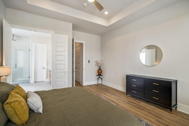 8411 Pech Landing Dr, Houston, TX 77055 - bedroom featuring wood finished floors, baseboards, a tray ceiling, and recessed lighting