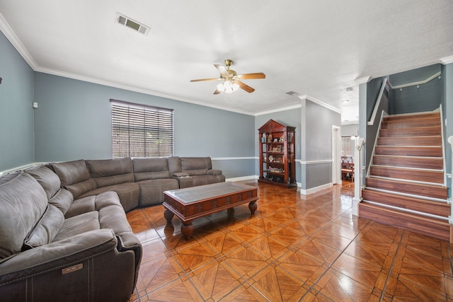 living area with stairway, a ceiling fan, and ornamental molding