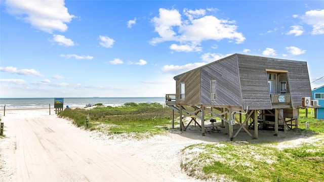 view of property's community featuring a beach view and a water view