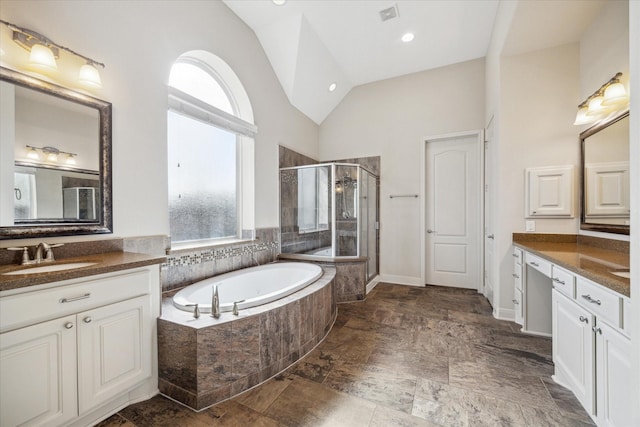 full bath featuring a garden tub, lofted ceiling, a sink, and plenty of natural light