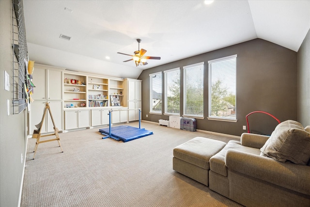 workout room with baseboards, visible vents, lofted ceiling, ceiling fan, and carpet floors