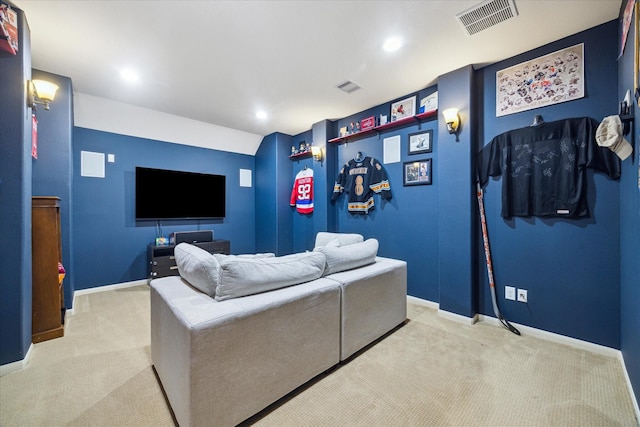 living area featuring light colored carpet, baseboards, and visible vents