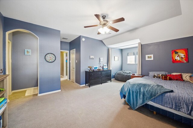 bedroom with visible vents, arched walkways, carpet floors, baseboards, and ceiling fan
