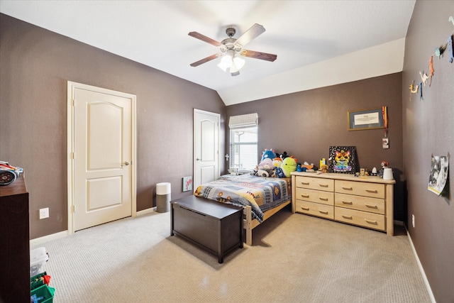 bedroom with light colored carpet, a ceiling fan, baseboards, and lofted ceiling