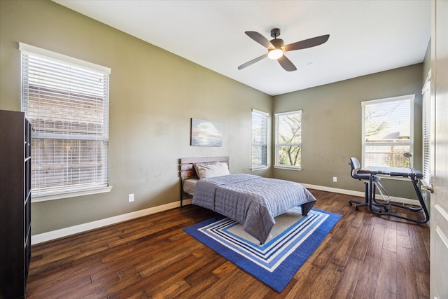 bedroom featuring baseboards, wood finished floors, and ceiling fan