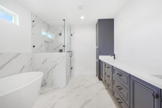 bathroom featuring a soaking tub, a marble finish shower, double vanity, recessed lighting, and marble finish floor