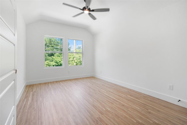 interior space with light wood finished floors, vaulted ceiling, baseboards, and a ceiling fan