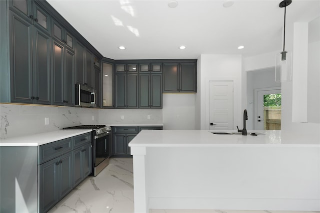 kitchen with marble finish floor, a peninsula, appliances with stainless steel finishes, and glass insert cabinets