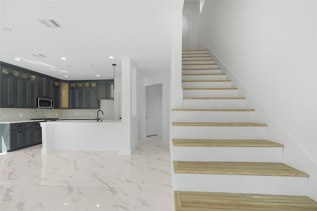 staircase with recessed lighting, visible vents, and marble finish floor
