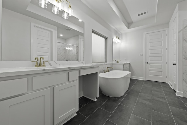 1159 Beals Creek St, Conroe, TX 77304 - full bathroom with a tray ceiling, a stall shower, vanity, and a freestanding tub