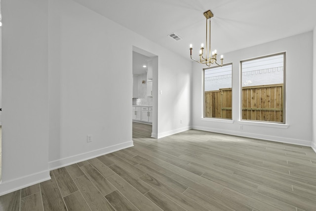 1159 Beals Creek St, Conroe, TX 77304 - unfurnished dining area with a chandelier and wood finished floors