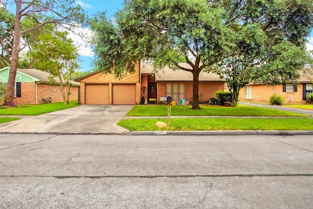 mid-century inspired home with brick siding, driveway, a garage, and a front yard