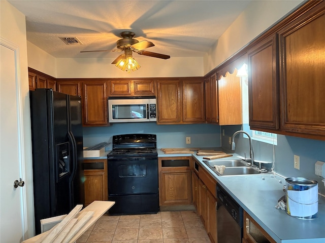 kitchen with a sink, black appliances, ceiling fan, light countertops, and visible vents