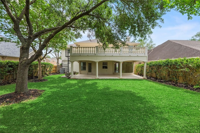 back of property featuring a wooden deck, a patio area, a lawn, stairway, and a fenced backyard