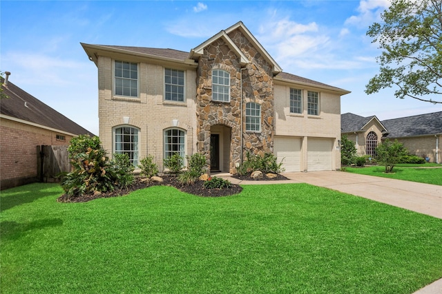 view of front of property featuring fence, stone siding, a front yard, concrete driveway, and an attached garage