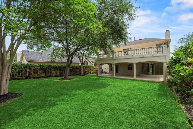 view of yard featuring fence, a wooden deck, and a patio area