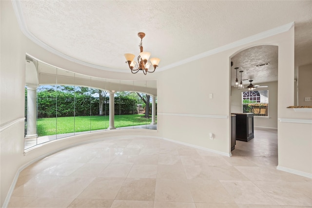 unfurnished dining area with light tile patterned floors, ornamental molding, ceiling fan with notable chandelier, baseboards, and a textured ceiling