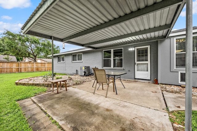 view of patio featuring central AC, fence, and outdoor dining area