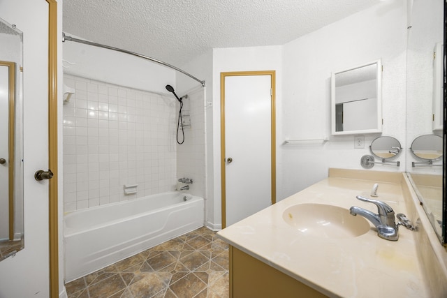 full bath with shower / bath combination, a sink, a textured ceiling, and double vanity