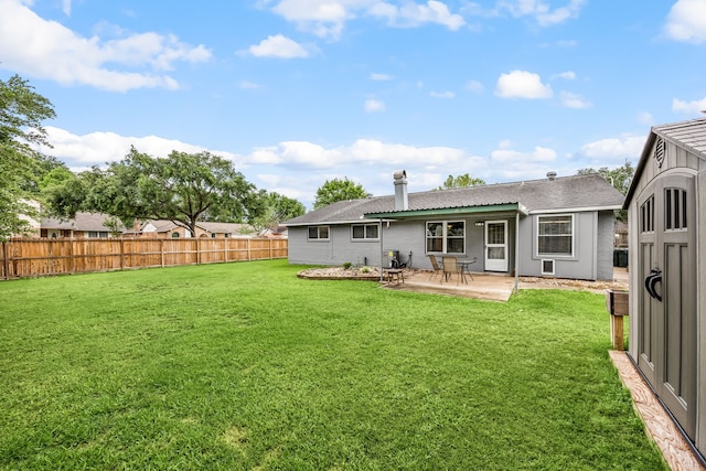 rear view of property with a yard, roof with shingles, a patio, and a fenced backyard