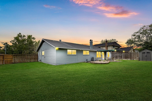 19302 Peach Valley Cir, Houston, TX 77084 - rear view of property featuring a storage shed, an outdoor structure, brick siding, a chimney, and central AC