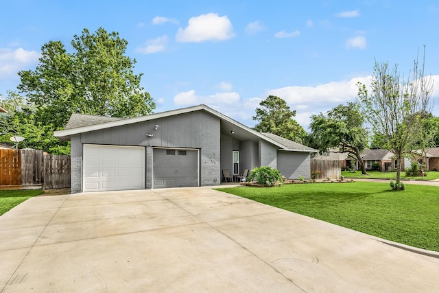 19302 Peach Valley Cir, Houston, TX 77084 - mid-century modern home featuring brick siding, an attached garage, driveway, and roof with shingles