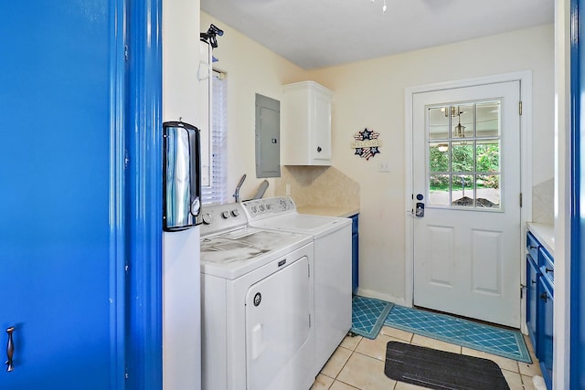 washroom with electric panel, separate washer and dryer, light tile patterned flooring, and cabinet space