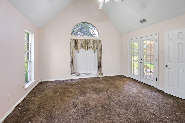 unfurnished room featuring visible vents, french doors, a healthy amount of sunlight, and high vaulted ceiling
