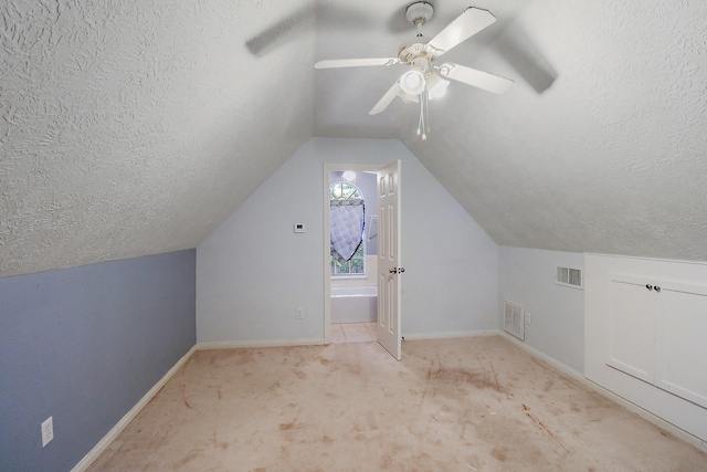 bonus room with lofted ceiling, carpet flooring, visible vents, and baseboards