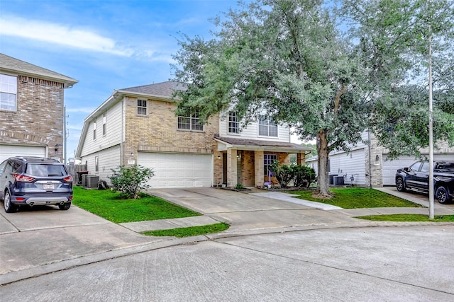 traditional-style home with central air condition unit, brick siding, driveway, and a garage