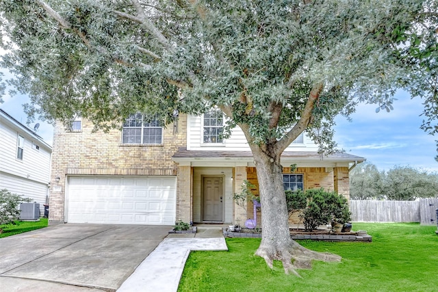 traditional home featuring fence, an attached garage, a front yard, concrete driveway, and cooling unit