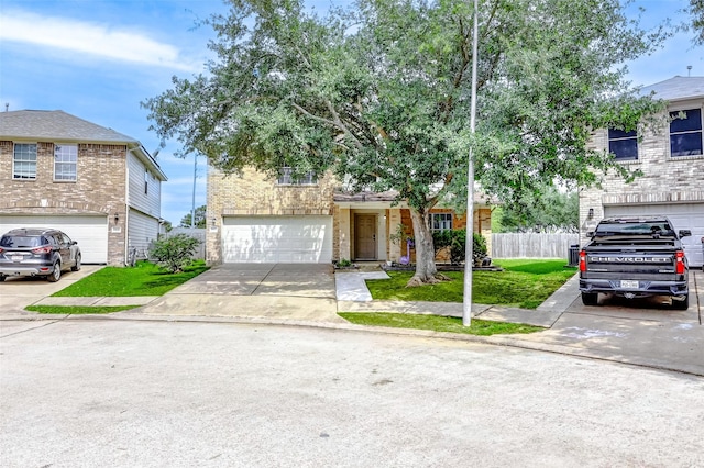 view of front facade with concrete driveway, brick siding, an attached garage, and fence
