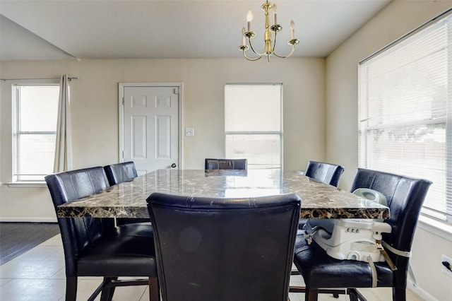 dining room featuring baseboards, tile patterned floors, and a chandelier