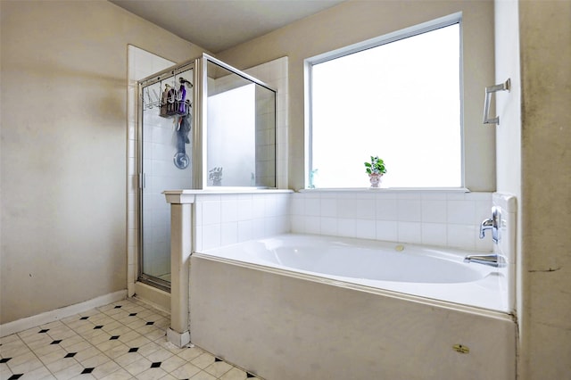 bathroom featuring tile patterned flooring, a garden tub, and a stall shower
