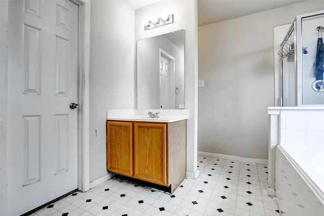 bathroom with an enclosed shower, baseboards, a tub to relax in, and vanity