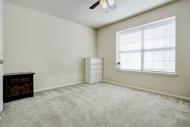 unfurnished bedroom with carpet floors, baseboards, and a ceiling fan