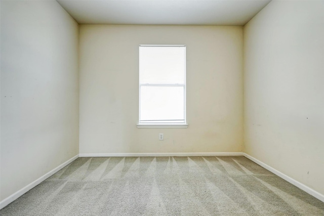 carpeted spare room with baseboards