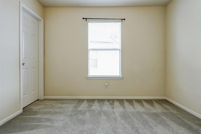 unfurnished room featuring baseboards and carpet flooring