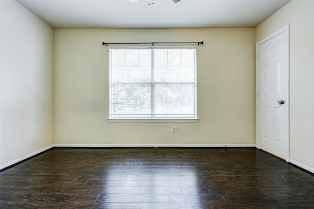 unfurnished room with baseboards, a healthy amount of sunlight, and hardwood / wood-style floors